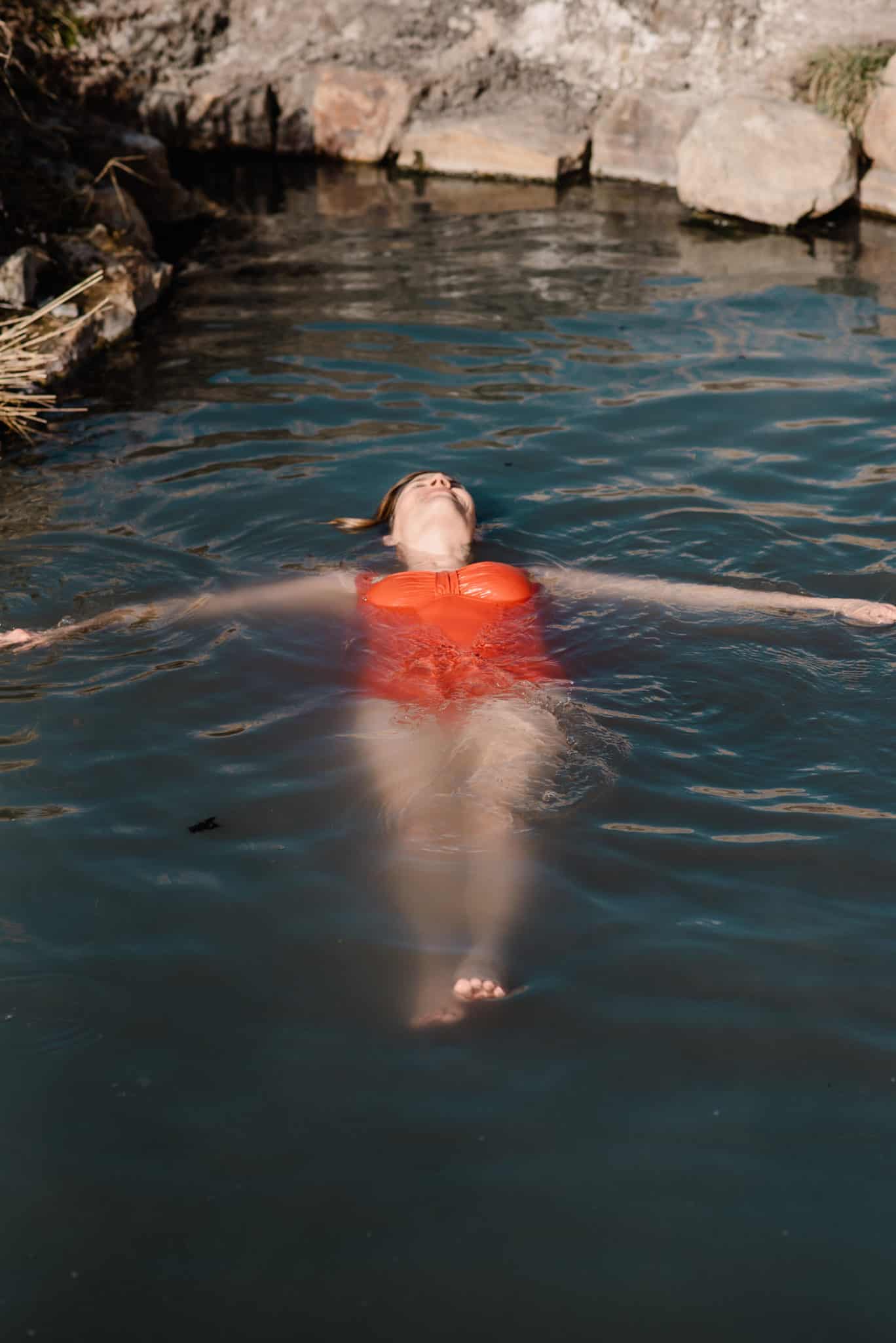female floating on water resting during a self worth meditation