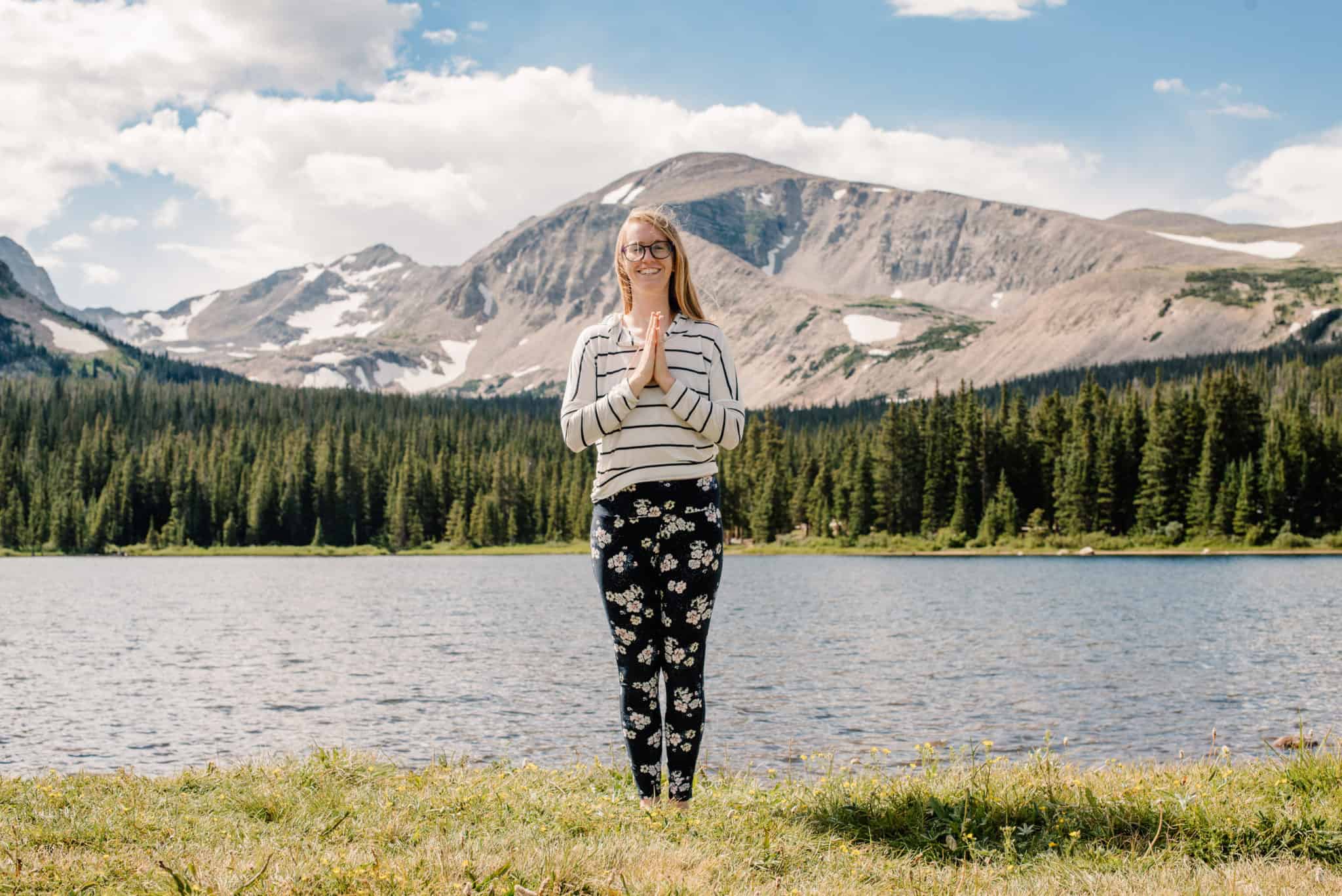 emmy in mountain pose, a great yoga pose for posture for beginners, outside near an alpine lake