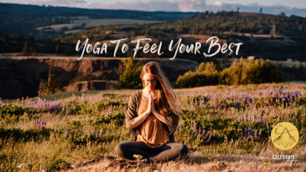 "yoga to feel your best" emmy sitting in simple seated on a cliff top with wild flowers all around