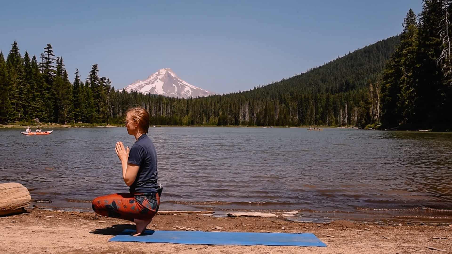 Emmy doing toe stand near an alpine lake for yoga to feel your best