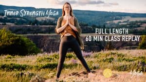 "inner strength yoga full length 60 min class replay" emmy standing in open a with hands at heart center on top of a mountain area