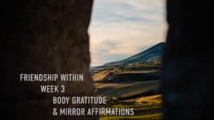 "Friendship within week 3 body gratitude and mirror affirmation" view threw two stone walls into a mountain and rolling hills illuminated by the setting sun