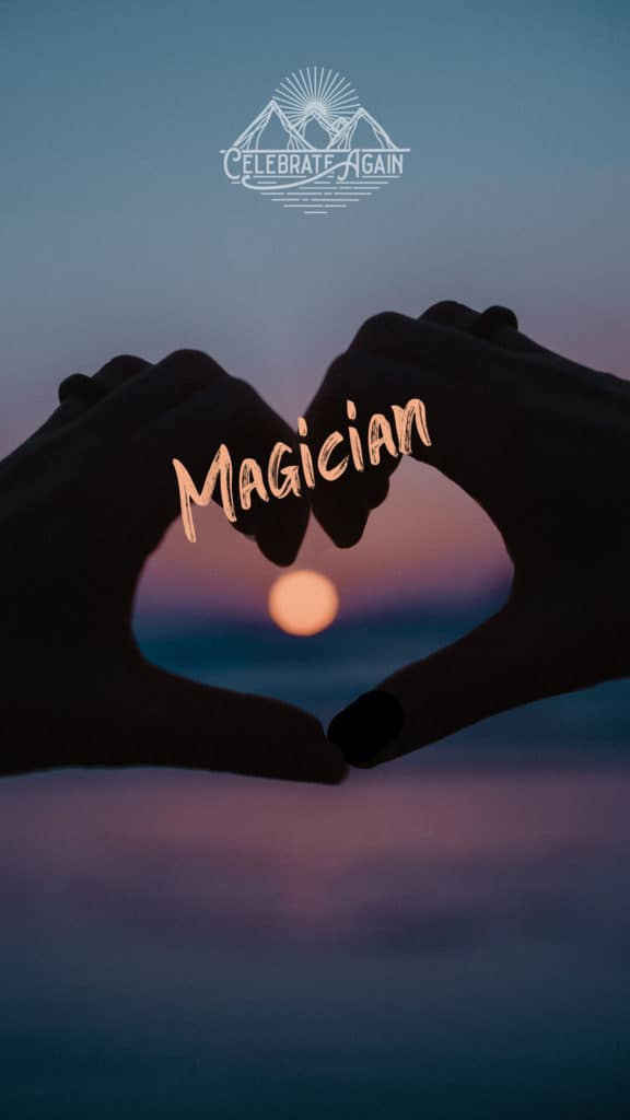 "magician" with hands in a heart around a colorful sunset