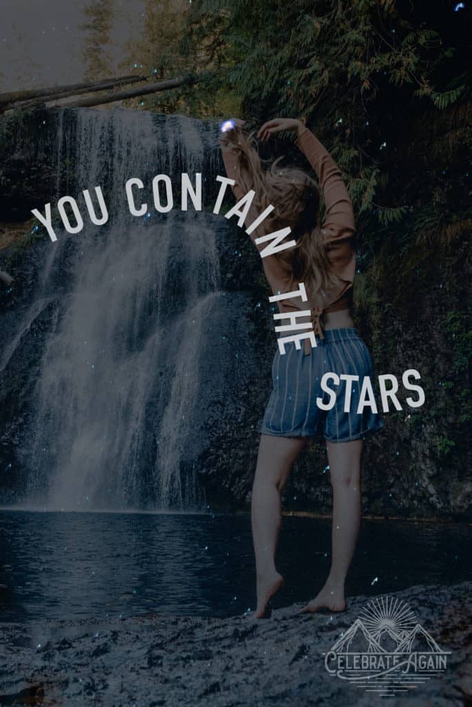 "you contain the stars" female by waterfall with arms up