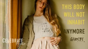 "this body will not inhabit anymore ghosts" my Lumalia with Celebrate Again a story header on stopping the generational trauma narrative. Lumalia against a wall with her shirt she screen printed "i am the plot twist"